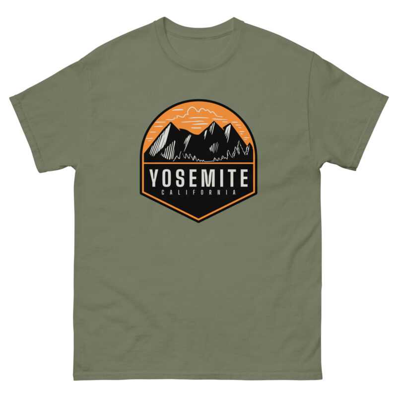 Introducing the YOSEMITE T-shirt by Evolve Shirts, featuring an olive green fabric with a captivating graphic design of majestic mountains set against an orange sky. The phrase "Yosemite California" is prominently displayed in bold white letters on a dark background, elegantly framed by an orange border.