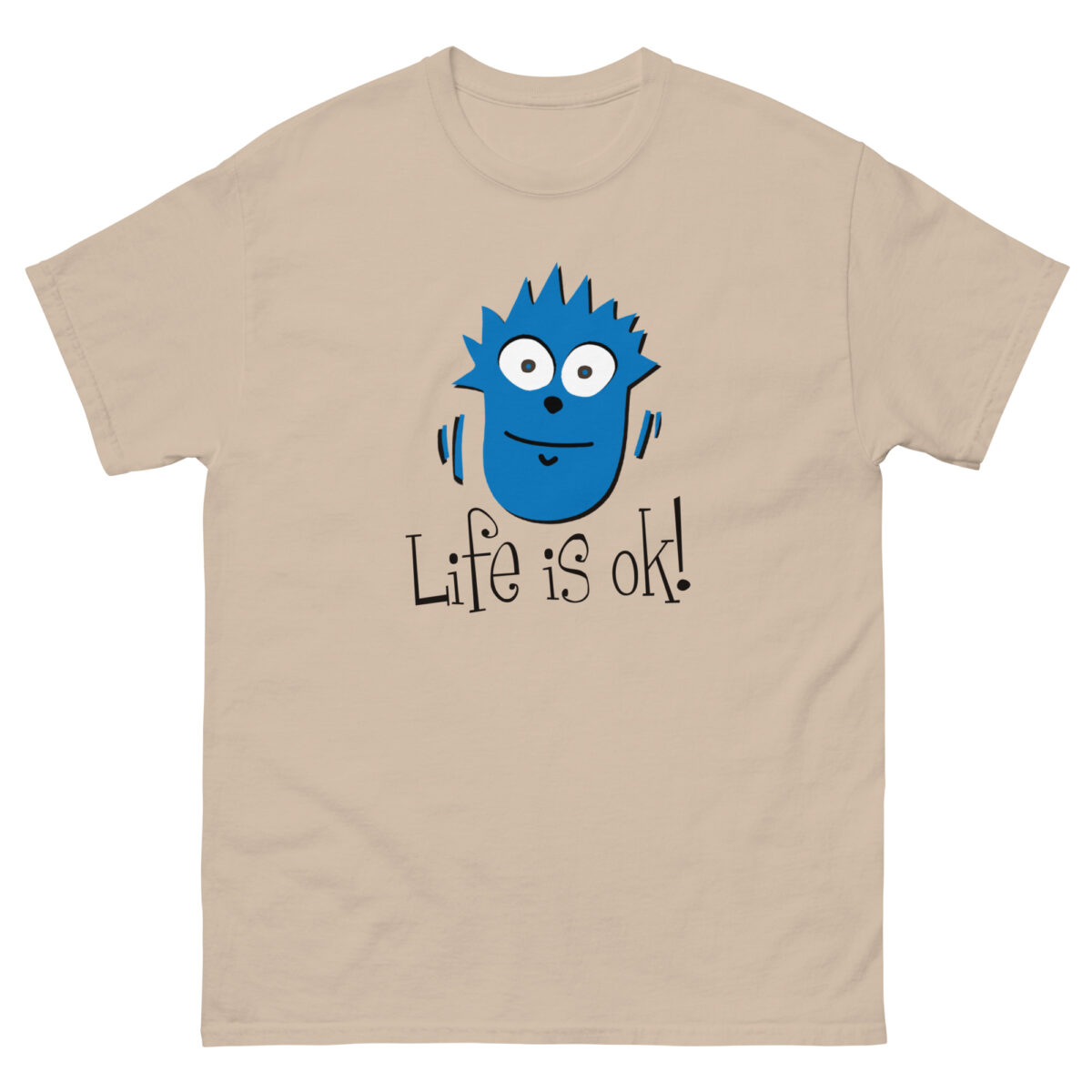 The beige "Life is ok! Generic" T-shirt from Evolve Shirts features a blue cartoon face with spiky hair and wide eyes. Beneath the image, the text reads "Life is ok!" in a playful font.